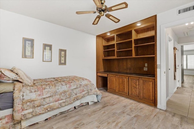 bedroom with light hardwood / wood-style floors and ceiling fan