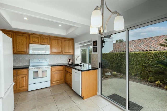 kitchen with pendant lighting, sink, white appliances, decorative backsplash, and a raised ceiling