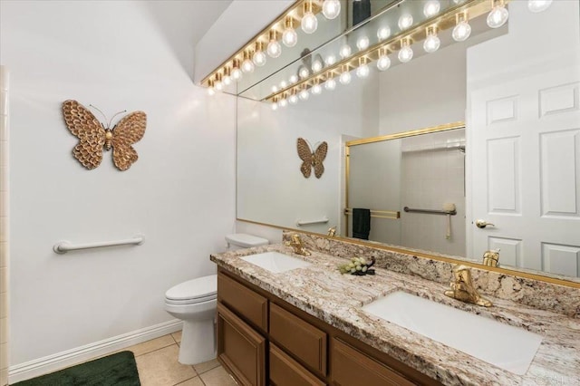 bathroom with tile patterned floors, toilet, a shower with shower door, and vanity