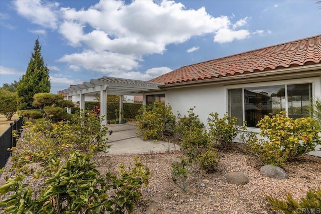 back of property with a pergola and a patio