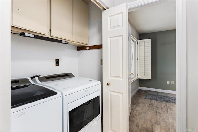 laundry room featuring cabinets, washer and clothes dryer, and light wood-type flooring