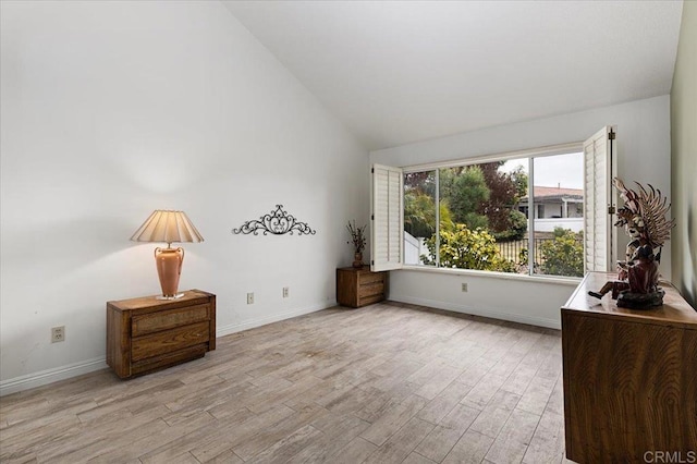 interior space featuring lofted ceiling and light hardwood / wood-style floors