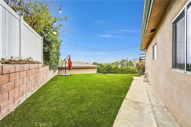 view of yard with a fenced backyard