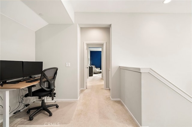 carpeted office with lofted ceiling