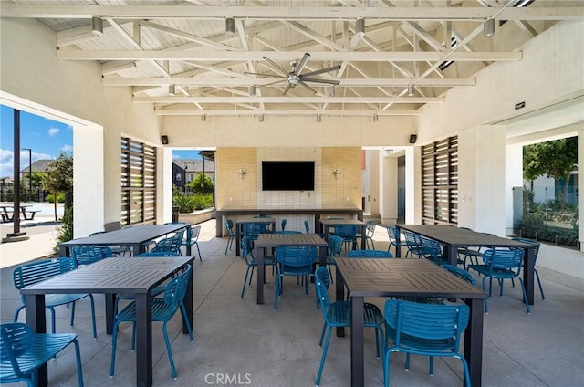 view of patio featuring a bar and ceiling fan