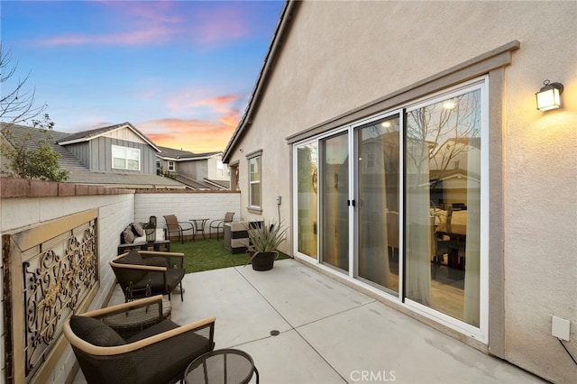 view of patio terrace at dusk