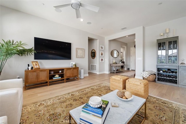 living room featuring ceiling fan and wood-type flooring