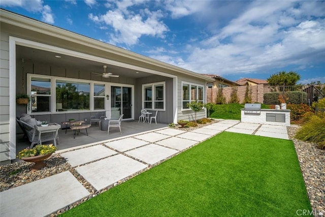 exterior space featuring ceiling fan, exterior kitchen, and a patio