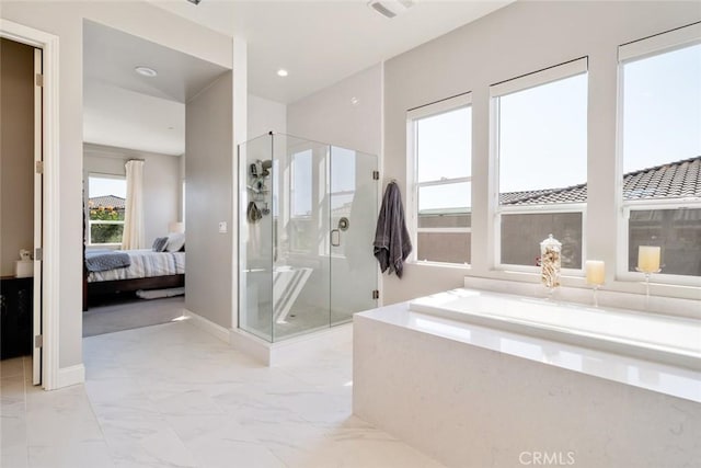 bathroom featuring shower with separate bathtub