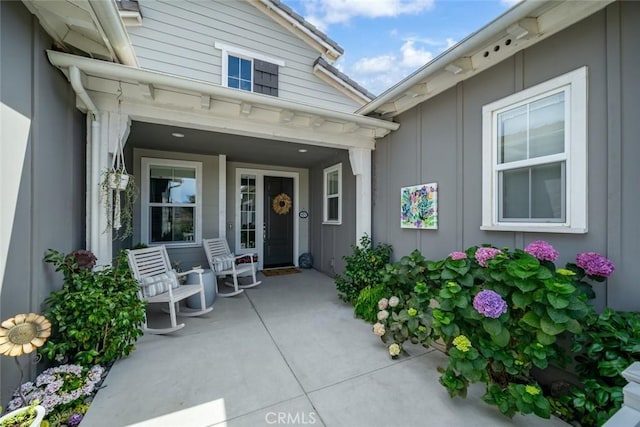 view of exterior entry featuring covered porch