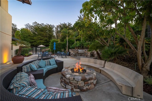 view of patio / terrace featuring an outdoor living space with a fire pit