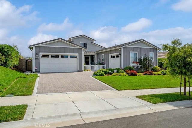 view of front of home featuring a garage and a front lawn