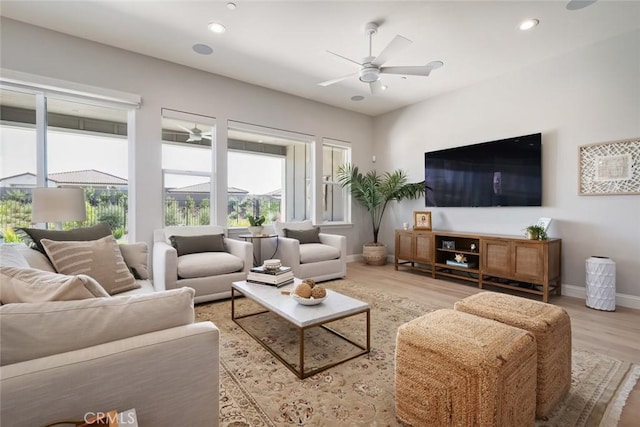 living room featuring hardwood / wood-style floors and ceiling fan