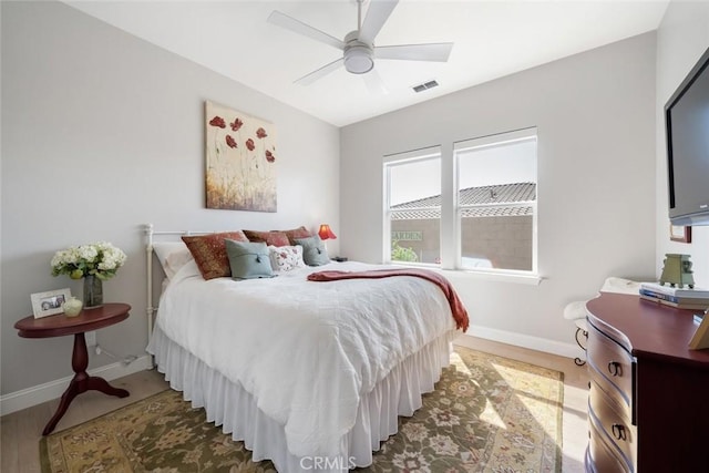 bedroom with wood-type flooring and ceiling fan