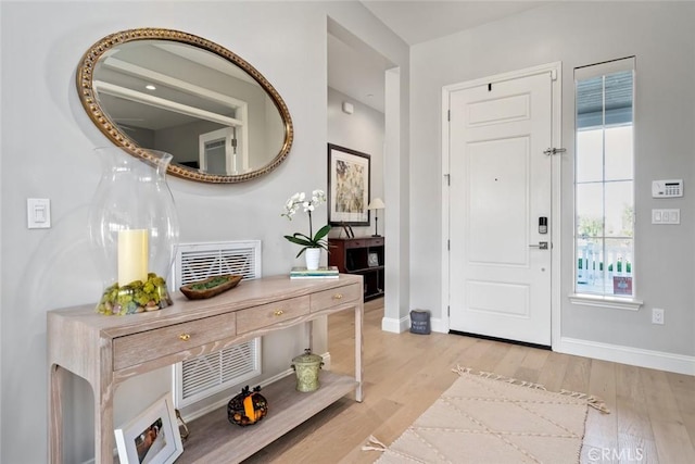 foyer entrance with light hardwood / wood-style floors