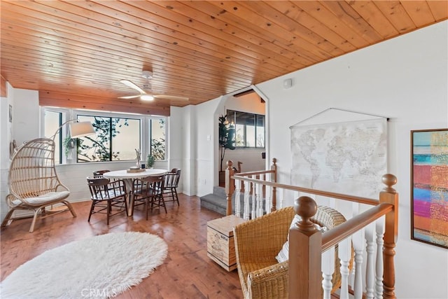 dining room featuring arched walkways, ceiling fan, wood finished floors, and wood ceiling