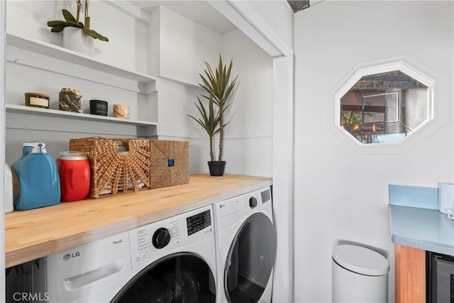 washroom featuring laundry area and washing machine and clothes dryer