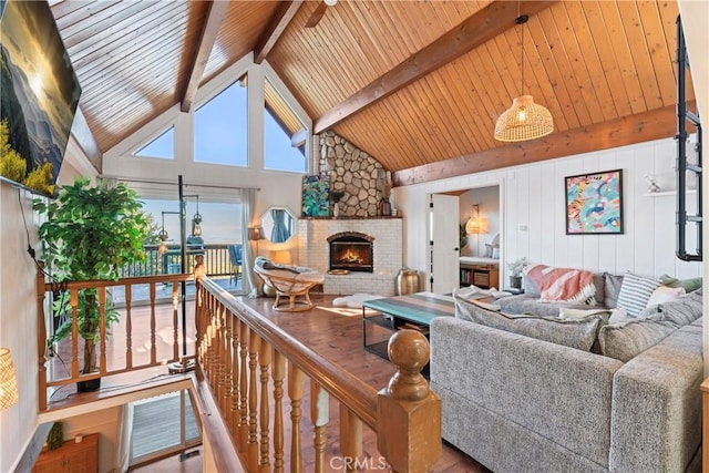 living room featuring wood ceiling, wood-type flooring, high vaulted ceiling, beamed ceiling, and a fireplace