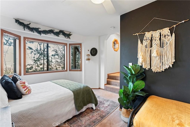 bedroom with a ceiling fan and baseboards