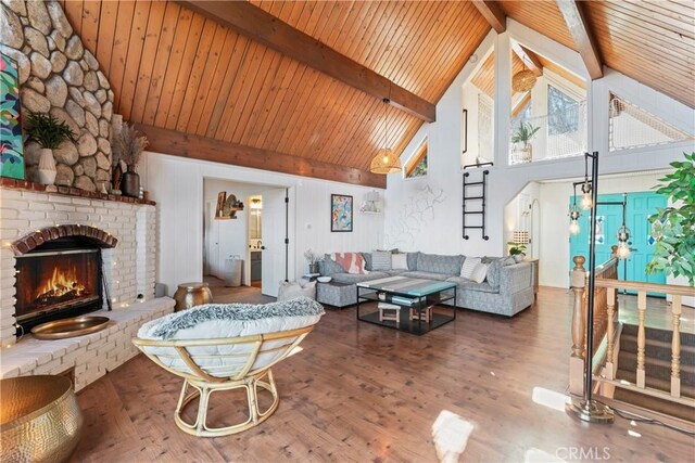 living room with high vaulted ceiling, a fireplace, wood-type flooring, wooden ceiling, and beam ceiling