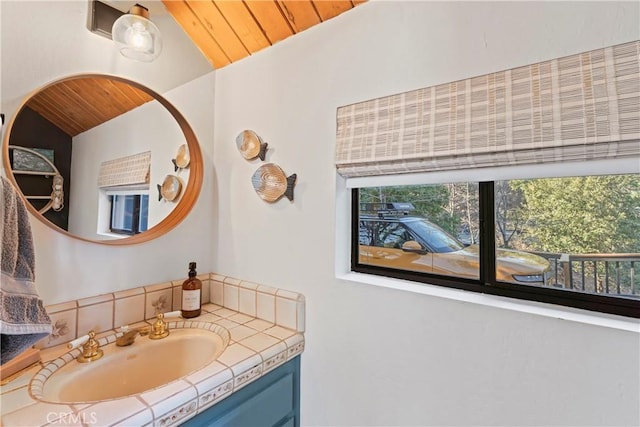 bathroom featuring lofted ceiling, wood ceiling, and vanity