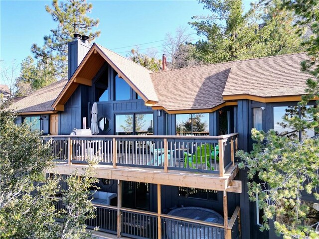 rear view of house featuring a deck