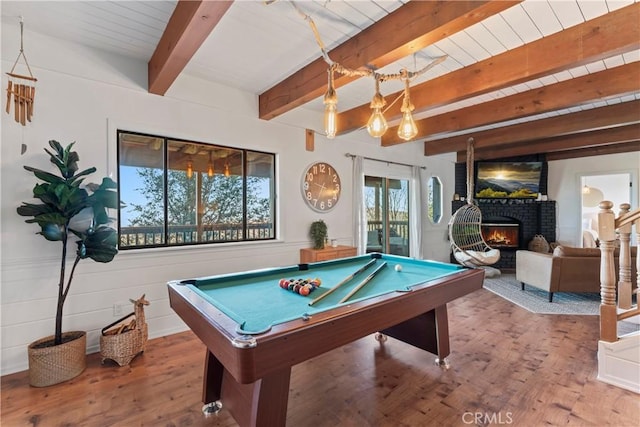 game room with wooden ceiling, wood finished floors, pool table, a fireplace, and beam ceiling