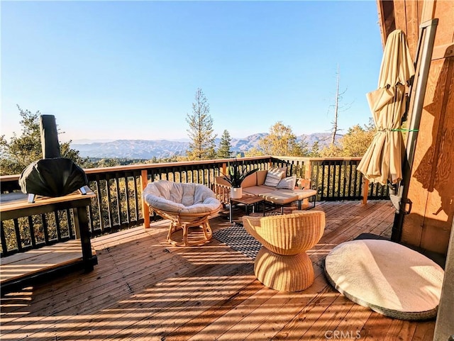 deck featuring a mountain view and outdoor lounge area