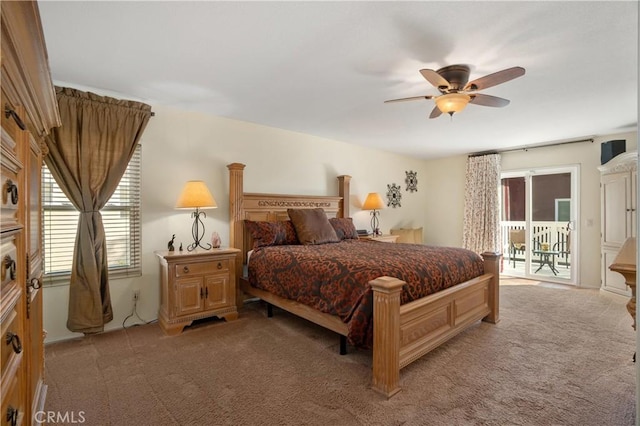 bedroom featuring multiple windows, light carpet, and access to outside