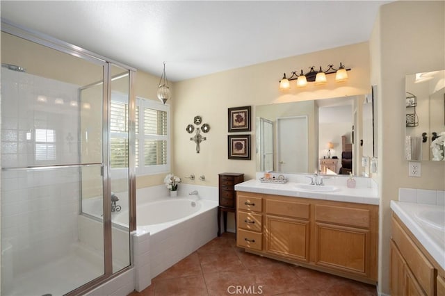 bathroom featuring tile patterned flooring, vanity, and separate shower and tub