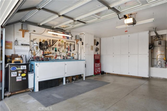 garage with a garage door opener, a workshop area, and secured water heater