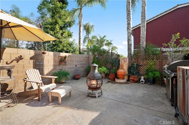 view of patio featuring grilling area and a fire pit