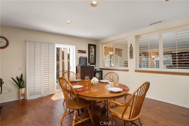 dining space with dark hardwood / wood-style flooring