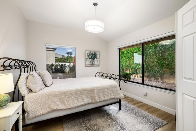 bedroom featuring lofted ceiling and hardwood / wood-style floors