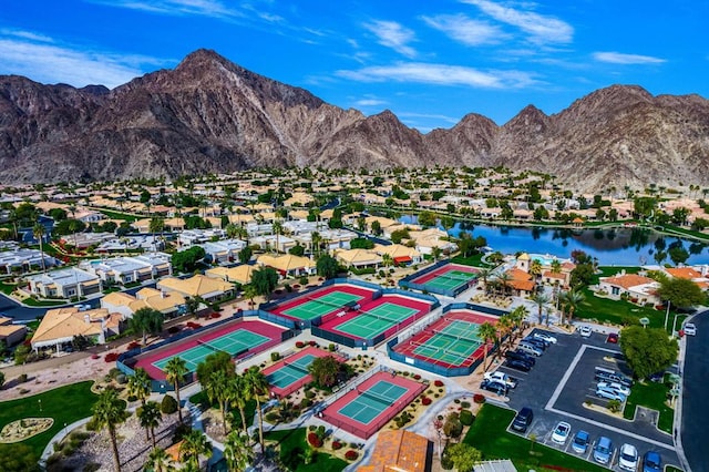 drone / aerial view featuring a water and mountain view