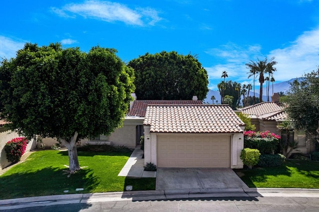 view of front of property featuring a garage and a front lawn