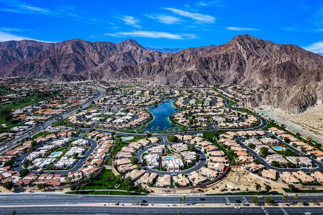 aerial view featuring a water and mountain view