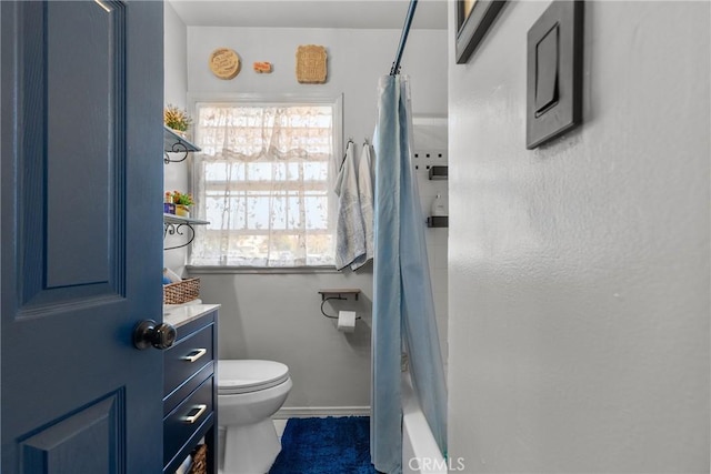 full bathroom featuring vanity, shower / bath combo, and toilet