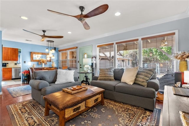 living room featuring hardwood / wood-style flooring, a wealth of natural light, ornamental molding, and ceiling fan