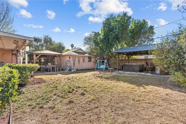 view of yard with a gazebo, a hot tub, and a patio area