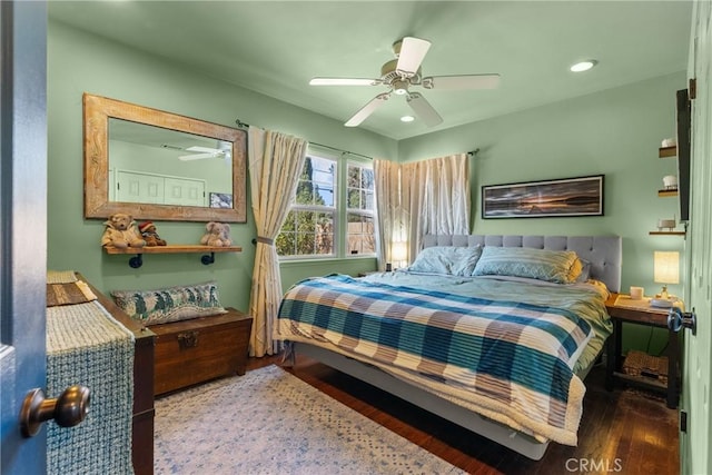 bedroom with ceiling fan and dark hardwood / wood-style flooring