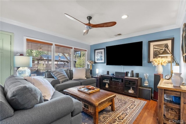 living room featuring hardwood / wood-style flooring, ceiling fan, and ornamental molding