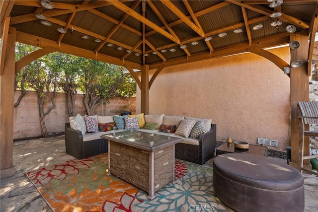 view of patio / terrace featuring a gazebo, an outdoor living space with a fire pit, and ceiling fan