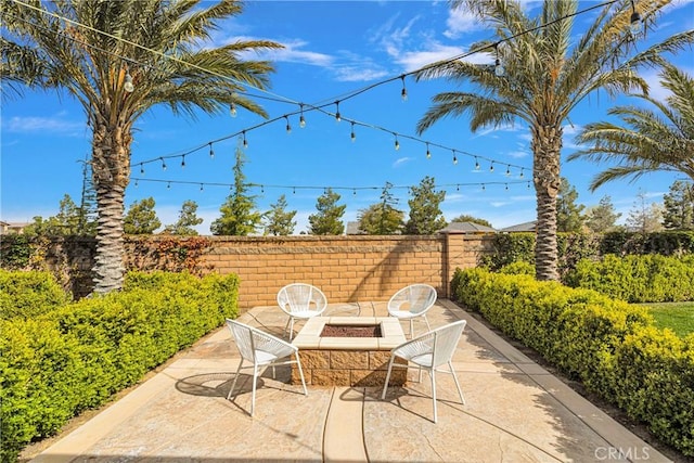 view of patio / terrace featuring an outdoor fire pit