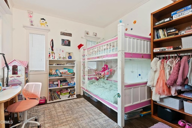 bedroom featuring crown molding and wood finished floors
