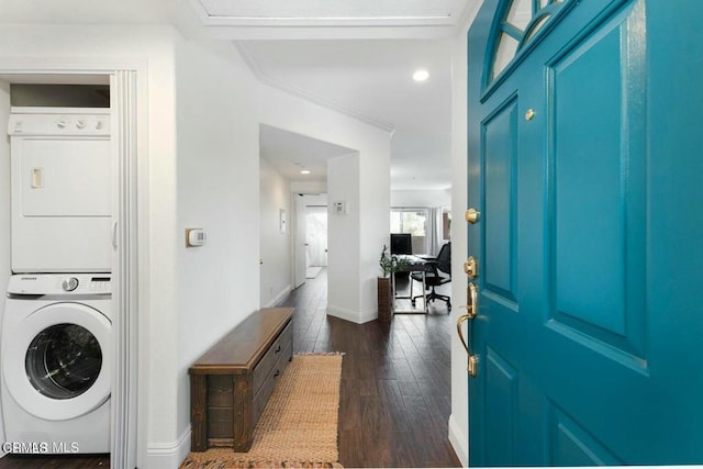 interior space featuring dark wood-style floors, baseboards, and stacked washer / dryer