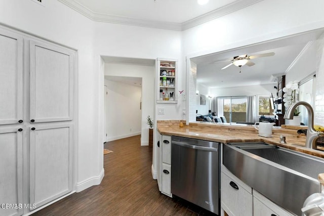 kitchen with dark wood finished floors, butcher block counters, ornamental molding, stainless steel dishwasher, and a sink