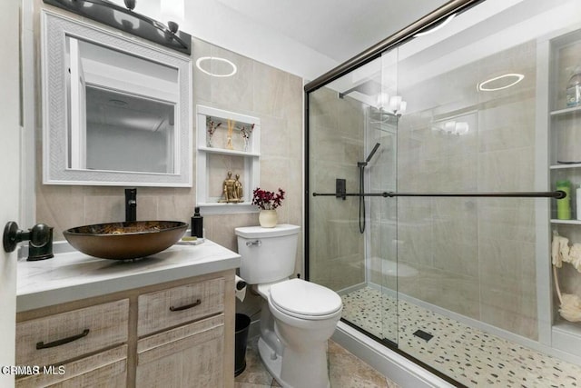 full bath featuring a shower stall, toilet, and vanity
