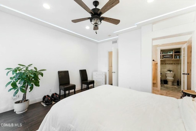 bedroom featuring visible vents, baseboards, dark wood-style flooring, ensuite bathroom, and recessed lighting