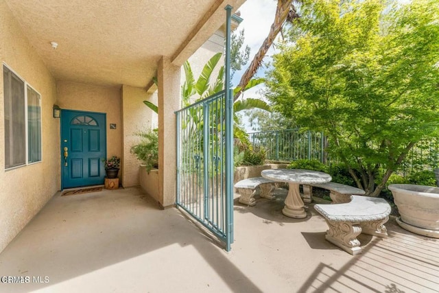 entrance to property featuring stucco siding